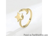The image is of a gold ring with a crescent moon and a star design. The ring is made of gold and has a simple and elegant des...