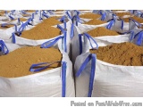 The image shows a large number of white bags filled with brown sand. The bags are arranged in a neat and orderly manner, with...