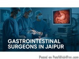 The image shows three surgeons performing an operation in an operating room. They are wearing blue surgical gowns, masks, and...