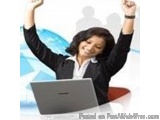 The image shows a woman sitting at a desk with a laptop in front of her. She is wearing a black blazer and has her arms raise...