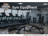 The image shows a gym with various exercise equipment. There are several treadmills, elliptical machines, and weightlifting m...