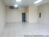 The image shows an empty room with white walls and a tiled floor. The room has a ceiling with recessed lighting and an air co...