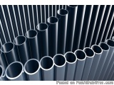 The image shows a group of black cylindrical pipes arranged in a grid-like pattern. The pipes are of different sizes and shap...