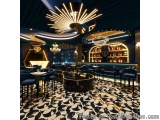 The image shows the interior of a luxurious bar or restaurant. The floor is covered in black and white geometric tiles, creat...