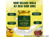 The image is an advertisement for UGM Village Wala A2 Desi Cow Ghee. The background is yellow and the product is in a glass j...