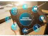 The image shows a person's hand holding a tablet with the words "Digital Marketing" in the center. Surrounding the tablet are...