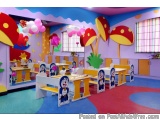 The image shows a colorful children's playroom with a variety of decorations. The walls are painted in a bright pink and blue...