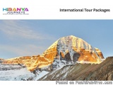 The image is a photograph of a mountain peak with a clear blue sky in the background. The mountain appears to be covered in s...