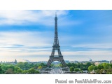 The image is a photograph of the Eiffel Tower in Paris, France. The tower is the focal point of the image, standing tall and...