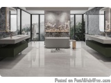 The image is of a modern and luxurious bathroom with a large window that offers a view of the greenery outside. The floor is...