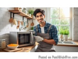 In this image, we can see a young man standing in a kitchen with a smile on his face. He is wearing a blue plaid shirt and a...