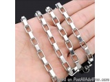 The image shows a hand holding a silver chain bracelet. The bracelet is made up of multiple rectangular links that are connec...