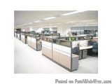 The image shows an empty office space with multiple cubicles arranged in rows. The cubicles are made of wood and have a moder...