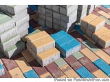 The image shows a pile of colorful bricks stacked on top of each other. The bricks are of different sizes and colors, includi...