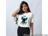 The image is a portrait of a young woman with long dark hair. She is wearing a white t-shirt with a graphic design on the fro...