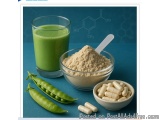 The image shows a glass of green smoothie, a bowl of powder, and a small bowl of capsules on a blue background. The glass is...