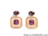 The image shows a pair of earrings. The earrings are made of gold and have a square shape with a pinkish-purple gemstone in t...