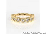 The image is of a gold ring with a thin band. The band is made of gold and has a row of small, round diamonds arranged in a z...